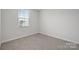 Simple bedroom with carpeted floor and window at 5008 Winding Jordan Ln, Charlotte, NC 28269