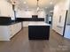 Modern kitchen with white and black cabinetry, large island, and quartz countertops at 444 19Th Avenue Nw Cir, Hickory, NC 28601