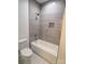 Bathroom with a shower and a bathtub, featuring grey tile at 444 19Th Avenue Nw Cir, Hickory, NC 28601