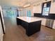 Modern kitchen with white and black cabinetry, large island, and quartz countertops at 444 19Th Avenue Nw Cir, Hickory, NC 28601