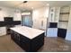 Modern kitchen with white and dark cabinetry, a large island and quartz countertops at 444 19Th Avenue Nw Cir, Hickory, NC 28601