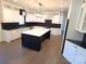 Modern kitchen with white and black cabinetry, a large island, and quartz countertops at 444 19Th Avenue Nw Cir, Hickory, NC 28601