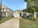 House with a white garage door and small yard at 851 Littleton Dr, Concord, NC 28025