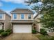 Modern two-story townhome with a stone facade and a two-car garage at 854 Summerlake Dr, Fort Mill, SC 29715