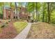 Brick house with a large backyard, firepit, and pathway at 10250 Barringer Ct, Mount Pleasant, NC 28124