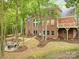 Brick home with a deck and fire pit in a wooded setting at 10250 Barringer Ct, Mount Pleasant, NC 28124