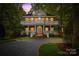 Grand two-story brick home with a charming front porch and landscaping at 10250 Barringer Ct, Mount Pleasant, NC 28124