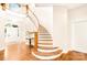 Grand curved staircase with wood accents and natural light at 10250 Barringer Ct, Mount Pleasant, NC 28124