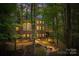 Landscaped backyard with firepit and deck, offering serene outdoor living at 10250 Barringer Ct, Mount Pleasant, NC 28124