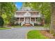 Brick two-story house with wrap-around porch and landscaped yard at 10250 Barringer Ct, Mount Pleasant, NC 28124