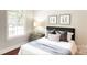 Charming bedroom with hardwood floors and a window overlooking the backyard at 10250 Barringer Ct, Mount Pleasant, NC 28124