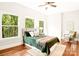 Charming bedroom with wood floors and forest views at 10250 Barringer Ct, Mount Pleasant, NC 28124