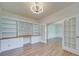 Home office with built-in shelving and hardwood floors at 2716 Manor Stone Way, Indian Trail, NC 28079