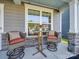 Cozy front porch with wicker seating and a small table at 2716 Manor Stone Way, Indian Trail, NC 28079
