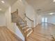 Elegant staircase with metal balusters leading to the upper level at 2716 Manor Stone Way, Indian Trail, NC 28079