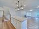 Open concept kitchen with island and view into living room at 2716 Manor Stone Way, Indian Trail, NC 28079