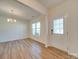 Bright dining room with hardwood floors and a chandelier at 2716 Manor Stone Way, Indian Trail, NC 28079