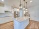 Kitchen island with granite countertop and pendant lighting at 2716 Manor Stone Way, Indian Trail, NC 28079