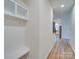 Hallway with built-in bench and storage, leading to kitchen at 2716 Manor Stone Way, Indian Trail, NC 28079