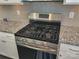 Stainless steel gas cooktop with five burners, situated on granite countertop at 16835 Cozy Cove Rd, Charlotte, NC 28278