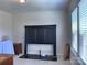 Bright bedroom with large windows and a dark headboard at 16835 Cozy Cove Rd, Charlotte, NC 28278