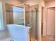 Bathroom with soaking tub and walk-in shower at 16835 Cozy Cove Rd, Charlotte, NC 28278
