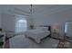 Spacious main bedroom with large windows, plush bedding, and a ceiling fan at 10604 Russet Pl, Charlotte, NC 28227