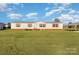 Single-wide mobile home with pink accents and a large yard at 408 Silk And Tassel Row, Cleveland, NC 27013