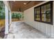 Covered patio with stone tile flooring and ceiling fan at 2305 Sanders Ave, Charlotte, NC 28216