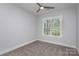Spacious bedroom with neutral walls, carpet flooring, and large window at 2305 Sanders Ave, Charlotte, NC 28216