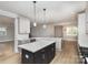 Open concept kitchen with island and breakfast bar at 2305 Sanders Ave, Charlotte, NC 28216