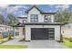 Modern two-story house with white siding, dark garage door, and landscaping at 2305 Sanders Ave, Charlotte, NC 28216