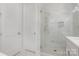 Bathroom with glass shower enclosure, marble tile, and modern vanity at 2305 Sanders Ave, Charlotte, NC 28216