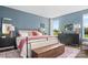Spacious bedroom with blue walls, plush bedding, and dark wood furniture at 5276 Scotts Creek Rd, Indian Land, SC 29707
