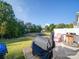 Backyard patio with grill, seating, and wooded backdrop at 13111 Cottage Crest Ln, Charlotte, NC 28273