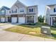 Two-story townhome with attached garage and manicured lawn at 13111 Cottage Crest Ln, Charlotte, NC 28273