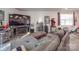 Finished basement with sectional sofa, large TV, and home gym at 13111 Cottage Crest Ln, Charlotte, NC 28273
