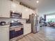 Modern kitchen with stainless steel appliances and island at 13111 Cottage Crest Ln, Charlotte, NC 28273