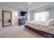 Bright bedroom with a large bed, dresser, and en-suite bathroom at 13111 Cottage Crest Ln, Charlotte, NC 28273