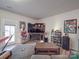 Spacious living area featuring a large TV and fireplace at 13111 Cottage Crest Ln, Charlotte, NC 28273