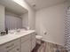 Main bathroom with shower/tub combo, toilet and vanity at 13111 Cottage Crest Ln, Charlotte, NC 28273