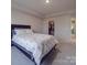 Bedroom with a queen-size bed and an adjacent walk-in closet at 13111 Cottage Crest Ln, Charlotte, NC 28273
