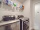 Laundry room with washer, dryer, and shelving at 13111 Cottage Crest Ln, Charlotte, NC 28273