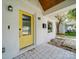 Covered porch with yellow door and brick facade at 1517 Kimberly Rd, Charlotte, NC 28208