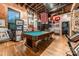 Game room with a pool table and exposed brick walls at 310 Arlington Ave # Multiple, Charlotte, NC 28203