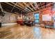 Living room features exposed brick walls, hardwood floors, and high ceilings at 310 Arlington Ave # Multiple, Charlotte, NC 28203