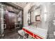 Modern bathroom with a glass shower, hexagonal tile, and red vanity at 310 Arlington Ave # Multiple, Charlotte, NC 28203