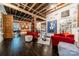 Spacious living area with exposed beams and red accent chairs at 310 Arlington Ave # Multiple, Charlotte, NC 28203