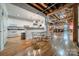 Open concept kitchen features exposed beams, hardwood floors, and modern appliances at 310 Arlington Ave # Multiple, Charlotte, NC 28203