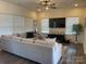 Living room with hardwood floors and large TV at 2022 Mcdonald Dr, Oakboro, NC 28163